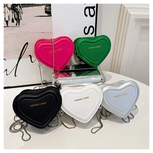 Collection of heart-shaped mini crossbody bags in five colors with metallic chain straps