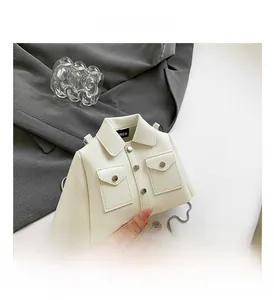 Close-up of shirt-shaped white leather handbag showing collar and silver buttons detail