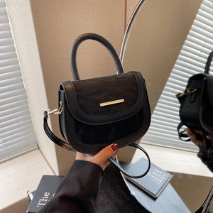 Chic two-tone leather saddle bag with gold metal buckle and cylindrical top handle