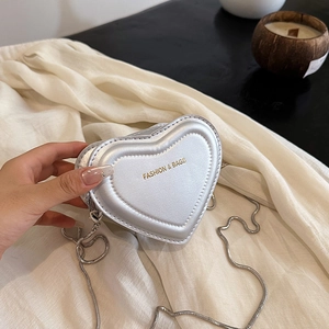 Chic silver heart-shaped crossbody bag with metal chain strap and luxury finish