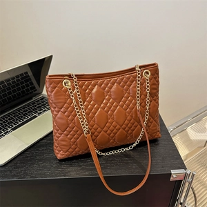 Deep brown quilted tote bag with gold chain straps for daily office commuting style