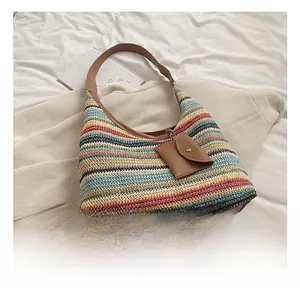 Detail of colorful striped woven shoulder bag with faux leather strap and coin purse