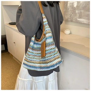 Detail of colorful chevron knit hobo bag with brown leather strap and card holder