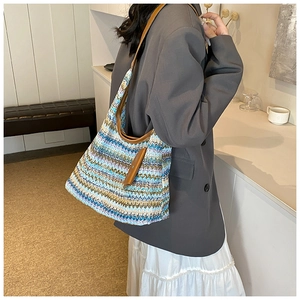 Detail of colorful woven shoulder bag with striped texture and premium leather strap