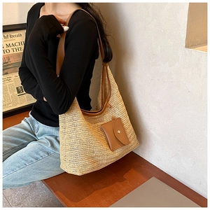 Detail of herringbone weave straw tote with brown leather straps and matching coin purse