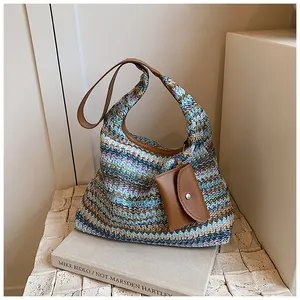 Detail of bohemian handmade woven bucket bag with chevron pattern and leather strap