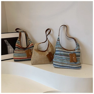 Detailed close-up of rainbow straw tote bags with leather straps and mini pouches