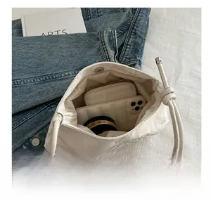 Top view of white crossbody bag interior showing large capacity for essentials