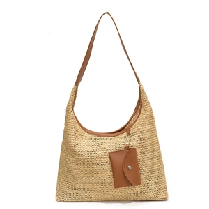 Handwoven straw shoulder bucket bag with brown leather trim and matching small pouch