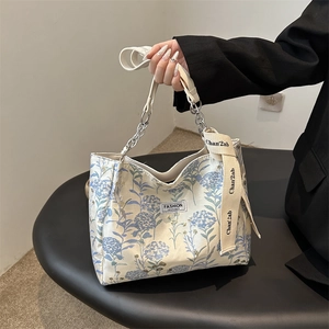 Floral canvas tote bag with silver chain handle and blue flower print for women