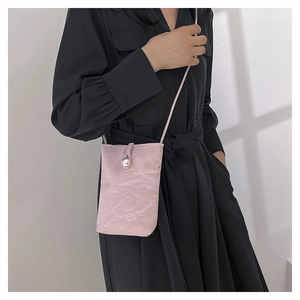 Light pink mini phone bag with unique wrinkled texture and decorative pearl detail