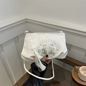 Cream embroidered crossbody bag with floral patterns and elegant long tassels