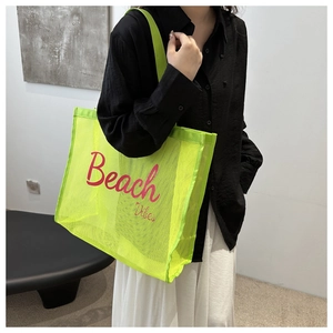 Close-up of neon green mesh tote bag with Beach Vibes text for beach and fitness