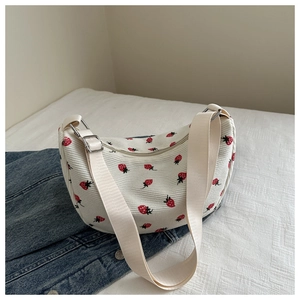 Close-up of strawberry print corduroy shoulder bag with adjustable canvas strap