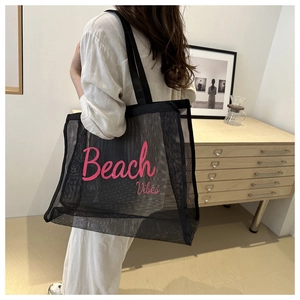 Detail view of large mesh beach tote bag with pink Beach Vibes print and nylon straps