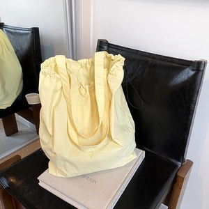 Bright yellow casual tote bag with drawstring closure for daily commuting and shopping