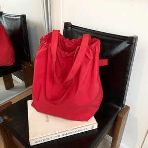 Large red nylon tote bag with drawstring pleated design for casual commuting use