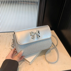 Silver square crossbody bag with glitter finish and a metal bow buckle for women