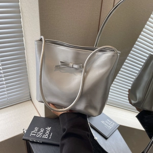Chic silver underarm tote bag with bow detail and metallic synthetic leather finish