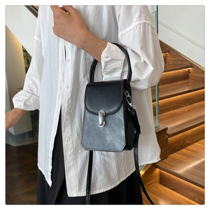 Detail of a vintage-style crossbody bag with marble texture flap and silver turn-lock clasp