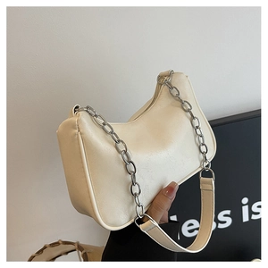 Detail of cream half-moon underarm bag with silver chain and leather dual straps