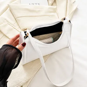 Internal capacity view of white hobo bag showing black lining and zipper closure