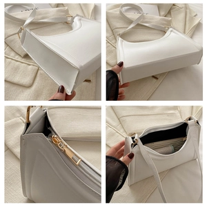Detail view showing minimalist white hobo bag stitching, golden hardware and interior space