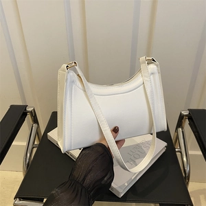 Minimalist white baguette underarm bag with smooth faux leather and top handle