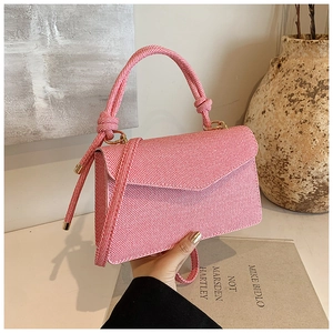 Detail of pink and white striped fabric handbag with unique rope knot handle design