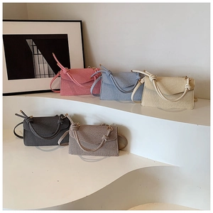 Detailed display of vintage flap crossbody bags in five colors with knotted rope handles
