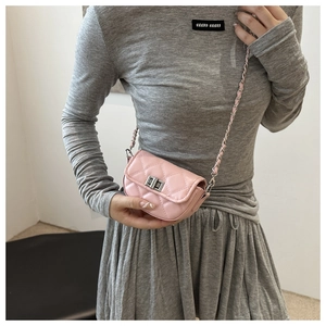 Detail of pink quilted leather mini bag with silver twist lock and chain strap