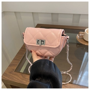 Detailed close-up of a pink mini crossbody bag with quilted pattern and silver chain strap