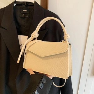 Elegant beige woven envelope bag with gold hardware and a braided handle for women