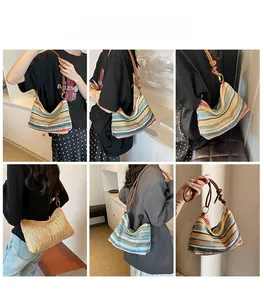 Detail of woven rainbow tote with leather strap and golden ring buckles for summer