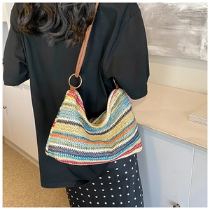 Macro detail of rainbow woven tote showing colorful knit texture and metal ring buckle
