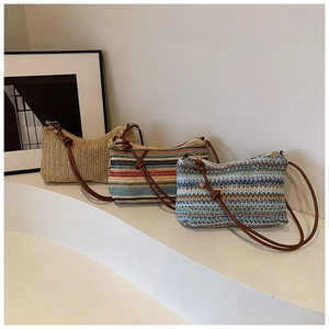 Close-up of rainbow striped woven tote bag with a brown knotted shoulder strap