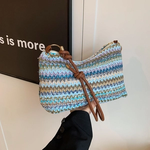 Rainbow striped woven tote bag with brown leather knotted handle and gold metal rings