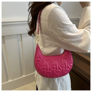 Detail of hot pink hobo bag featuring 3D geometric embossed texture and golden zipper