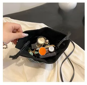 Top view of rhinestone bucket bag interior showing large capacity for cosmetics and lipsticks