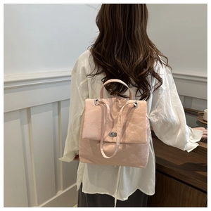 Rear view of a pale pink nylon backpack with silver twist-lock and minimalist Korean style