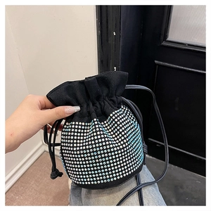 Detail of black drawstring bucket bag with sparkling silver rhinestones and thin strap