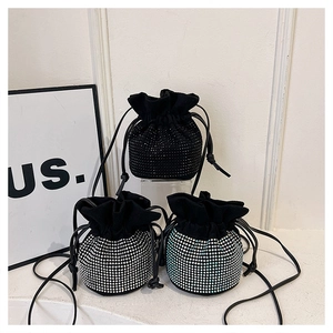 Three rhinestone drawstring bucket bags in black, silver and multi-color on display
