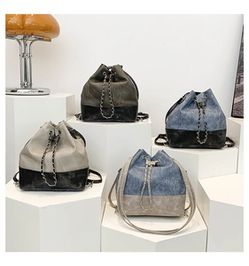 Detailed view of bucket backpacks with thick chain straps and drawstring closure in four colors