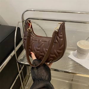 Coffee brown crescent shoulder bag with geometric quilted texture and gold hardware