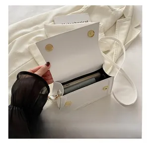 White faux leather crossbody bag interior showing phone and wallet storage capacity