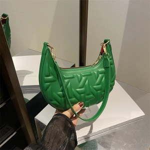 Green crescent shoulder bag with geometric 3D embossed texture and gold zipper