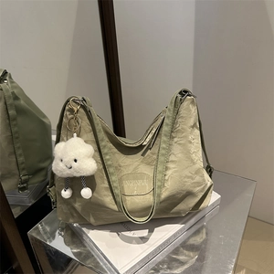 Light green large capacity backpack for women with soft texture and cloud charm detail