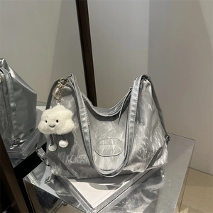 Metallic silver hobo bag with crinkled texture and cute white plush cloud charm for women