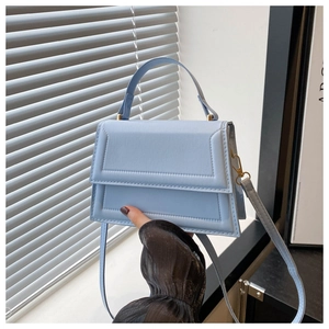 Light blue faux leather square handbag with top handle and gold metal hardware details