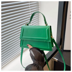 Detail of lime green faux leather handbag showing lychee texture and fine stitching